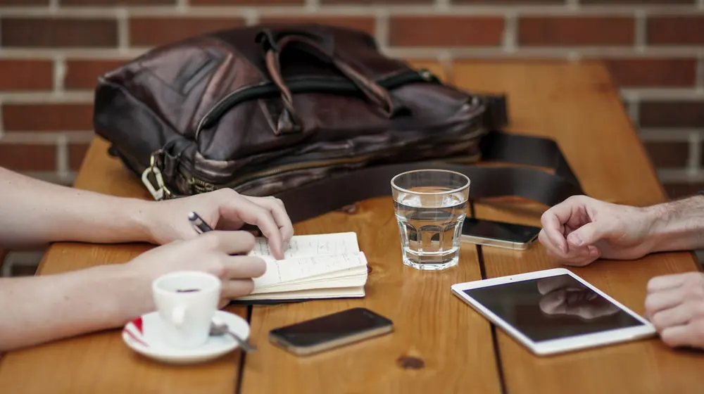 Two people talking across a table
